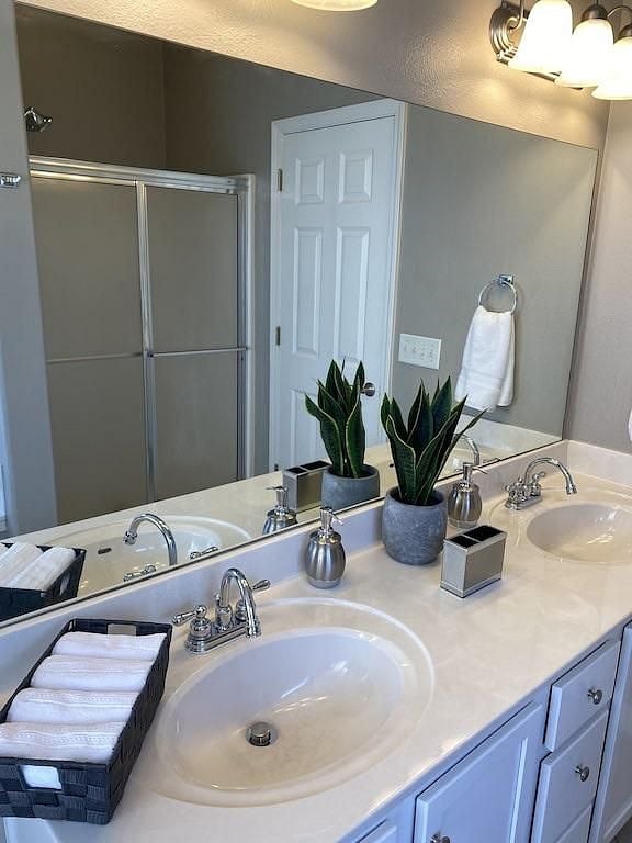 Full size shower with sliding glass doors.