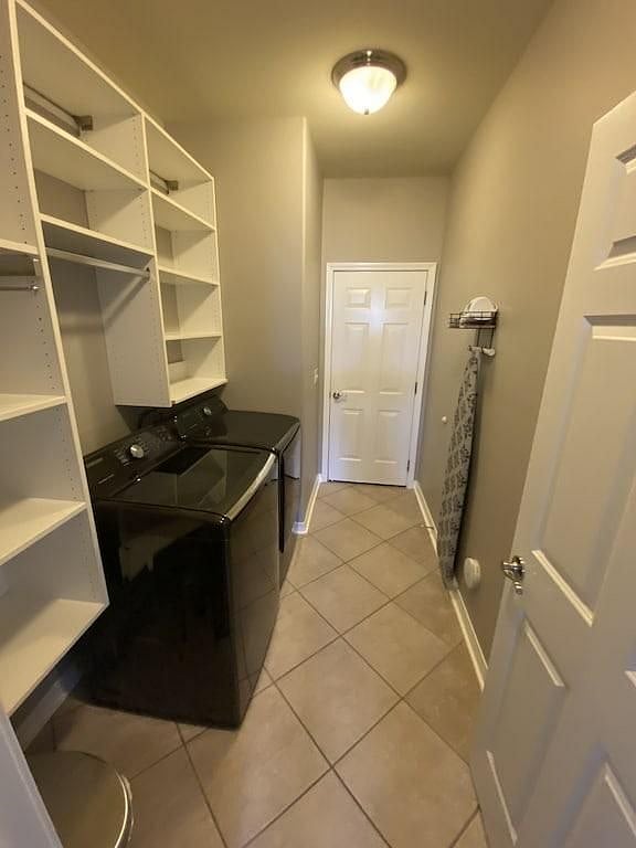 Laundry room offers Samsung washer/Dryer and ironing board and iron.