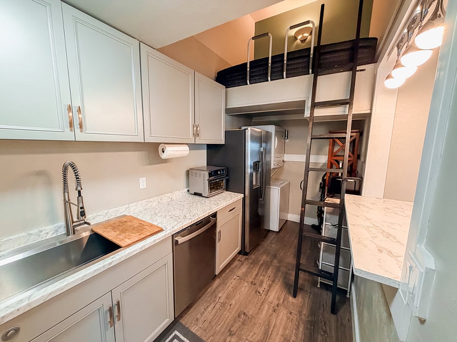 Kitchen and laundry room. Also, there is a loft, but probably won't be used since the unit is designed for one person.