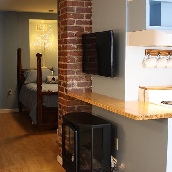 Wooden counter divides kitchen from loveseat/TV nook