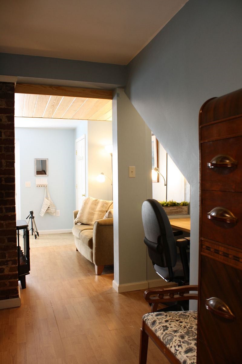 From the bed, the study nook and loveseat/TV nook are visible.