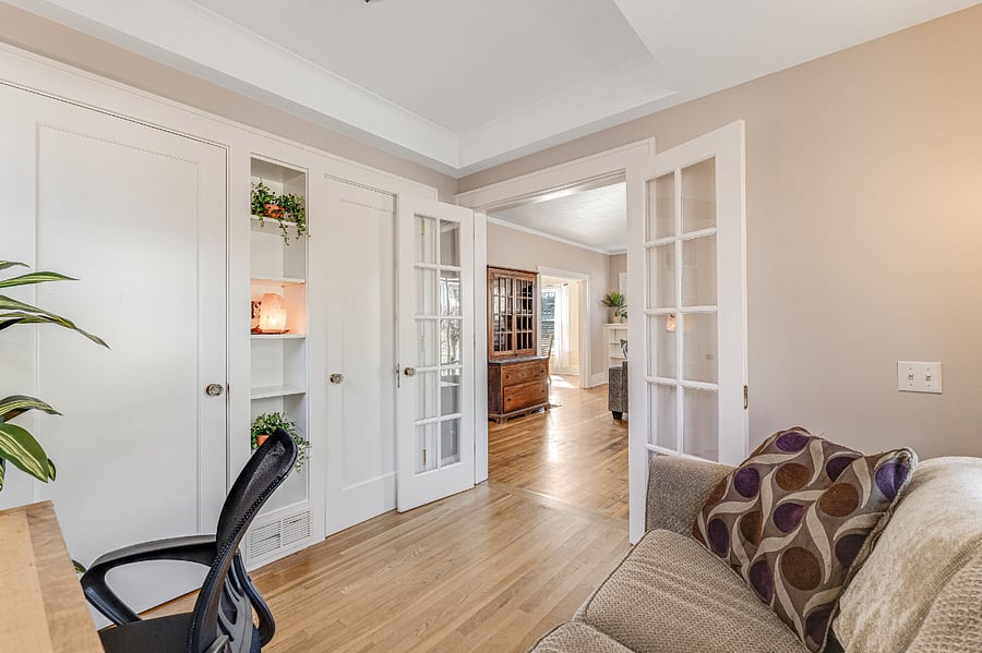 French doors lead into living room. Plenty of storage in closet and on shelves.