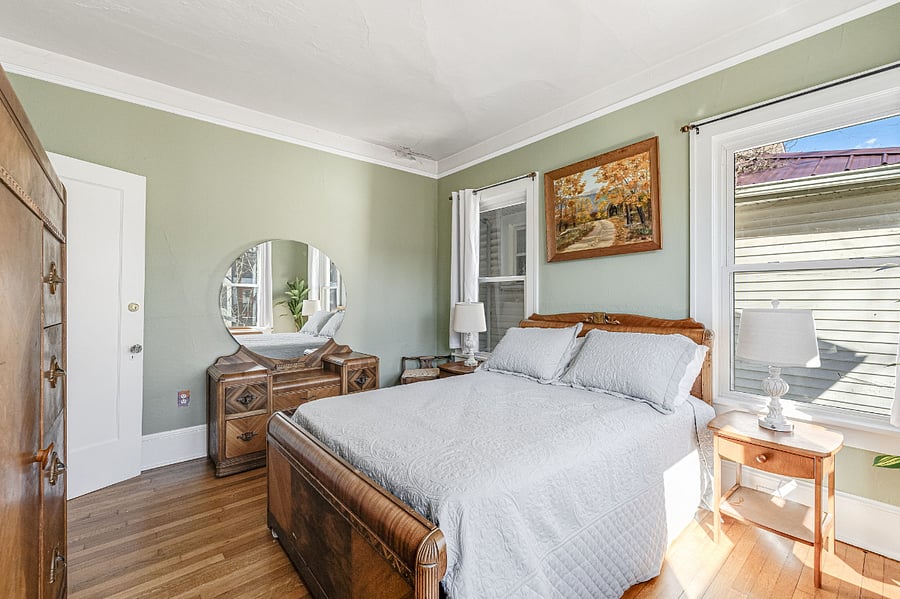 Sunny bedroom with antique Art Deco furniture, "waterfall" style, night tables, and touch lamps with built-in iphone chargers