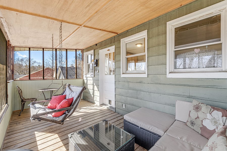 Screened in back porch off the kitchen, with small bistro set for 2, porchswing