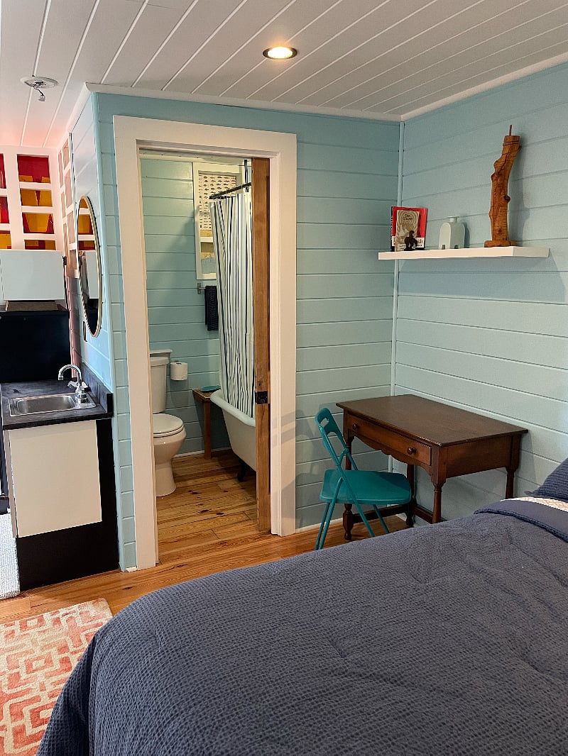 Desk and chair. The bathroom has a sliding pocket door.
