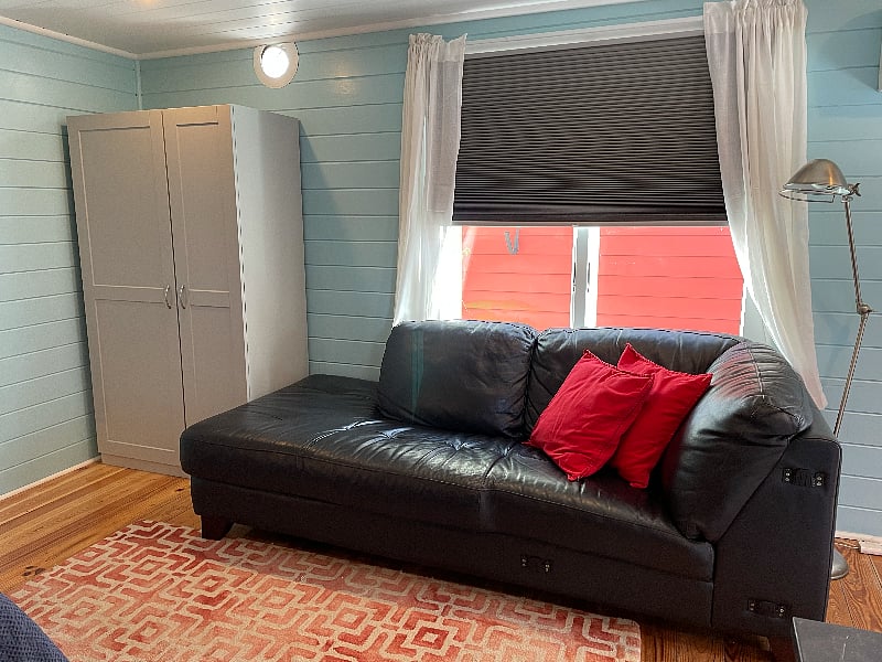 Comfy leather couch and wardrobe.