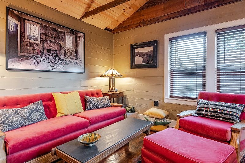 A. Brandt Ranch Oak furniture covered in velvet completes this space for a contemporary and comfortable feel. This furniture was made in Fort Worth in the late 1930s to the mid-late 1980s. Sit back and relax and enjoy this comfortable space!