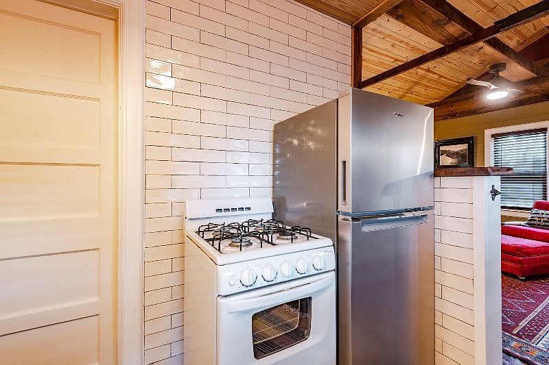 It may be small but this stove can cook and it's GAS! There is also a vent hood that has been recently added to this space.