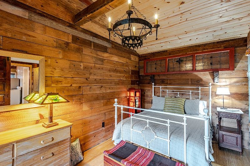 Love white iron beds? This space is for you. Cozy and quiet, this is the perfect sleeping space including the vaulted ceiling and antique Spanish chandelier.