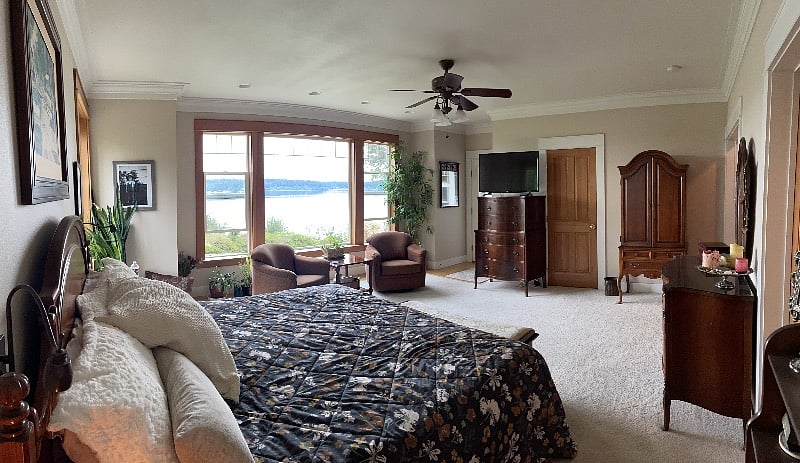 Master bedroom with king size bed.  Television is on bureau.