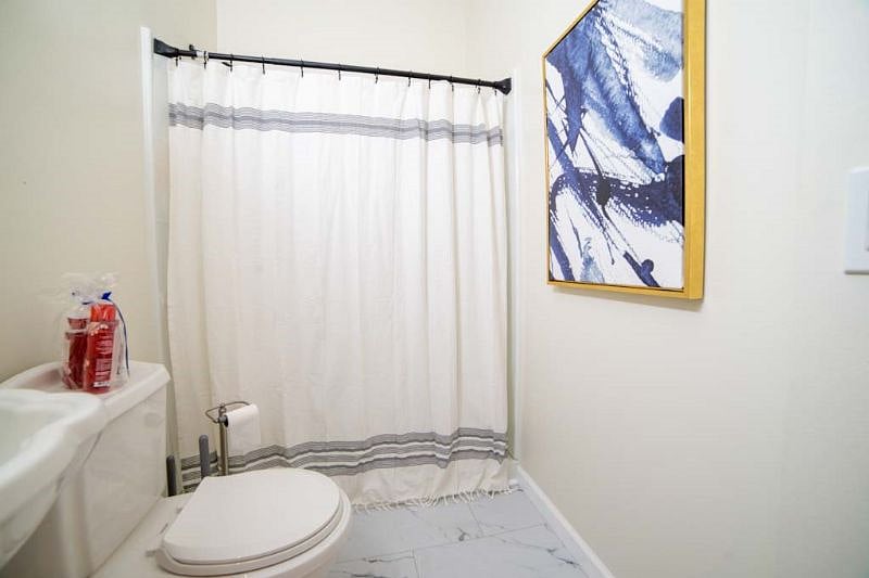Spacious bathroom with unique artwork