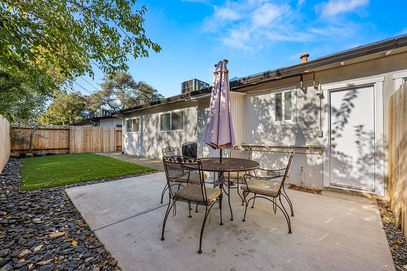 Backyard with patio, dining table, and BBQ