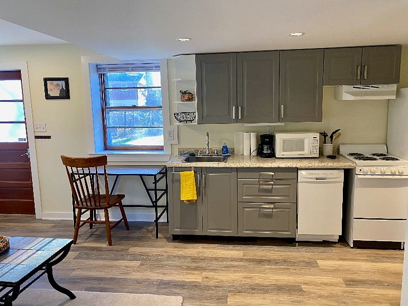 Kitchen includes stovetop, oven, dishwasher, and refrigerator.