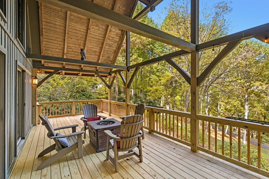 chairs and fire pit on covered deck