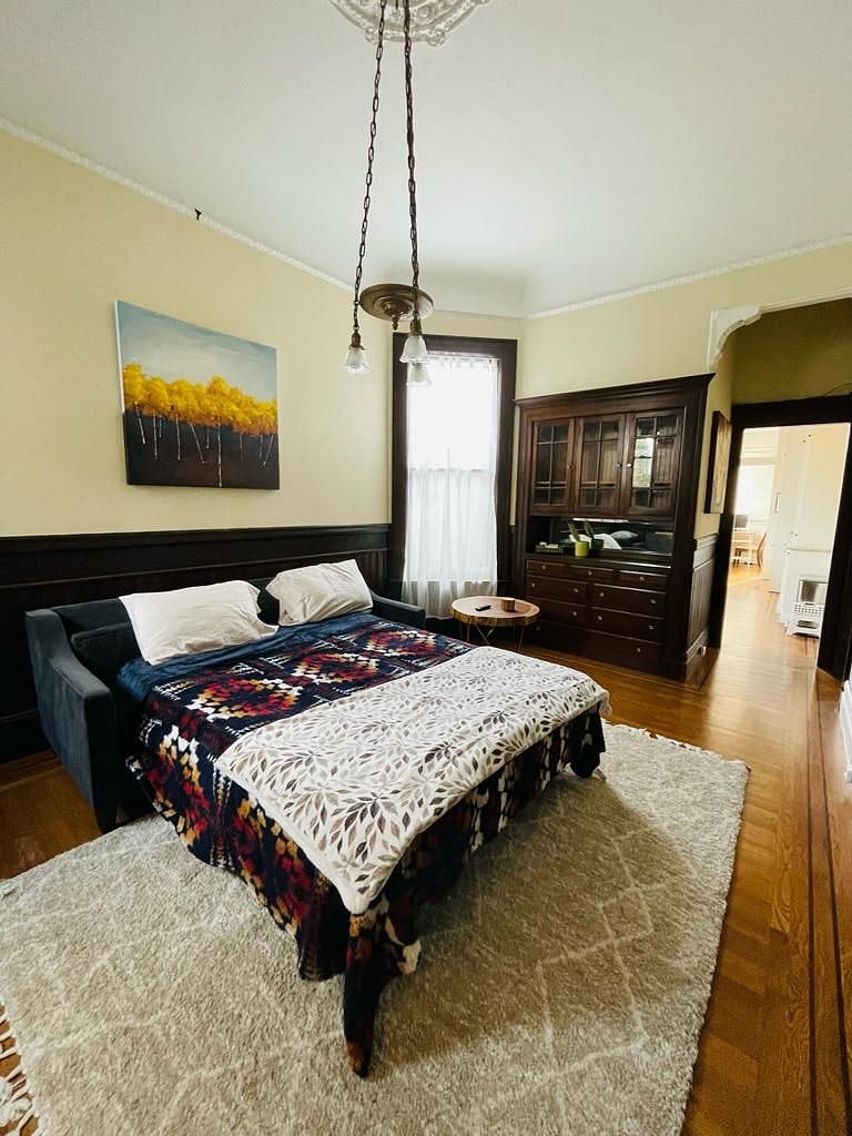 Voila! Double bed at the living room ready for a good rest (storage included).
