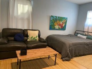 UPSTAIRS BEDROOM WITH COUCH AND COFFEE TABLE