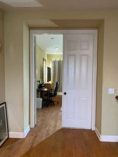 ENTRY DOOR TO MASTER BEDROOM, WITH EXECUTIVE DESK AND CHAIR.