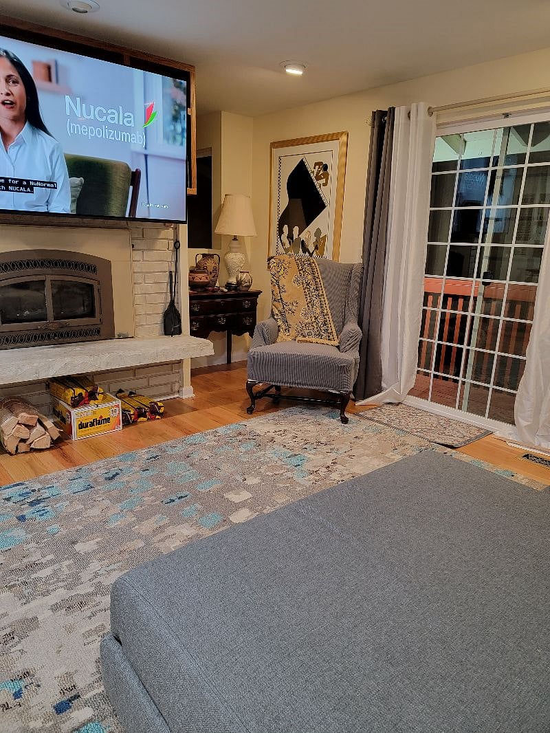 Livingroom with fireplace and big screen HD TV.
