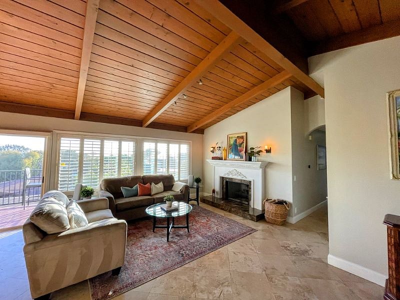Living room with gas fire place with gorgeous views of the ocean and sunset.