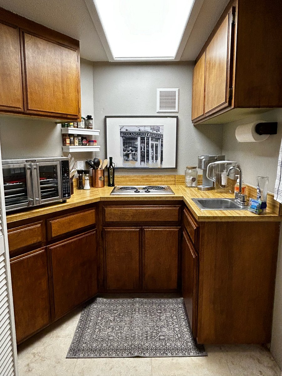 Kitchenette with 2 burners, sink, refrigerator and Air fryer/convection oven and Keurig coffee maker.