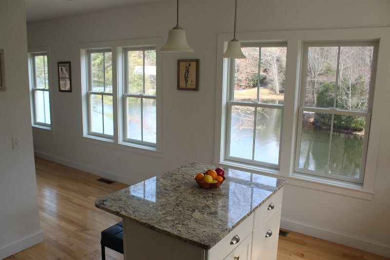 Kitchen with full wall of windows looking out on lake
