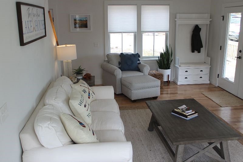 Living Room open concept with Dining and opens to two French doors deck overlooking lake.
