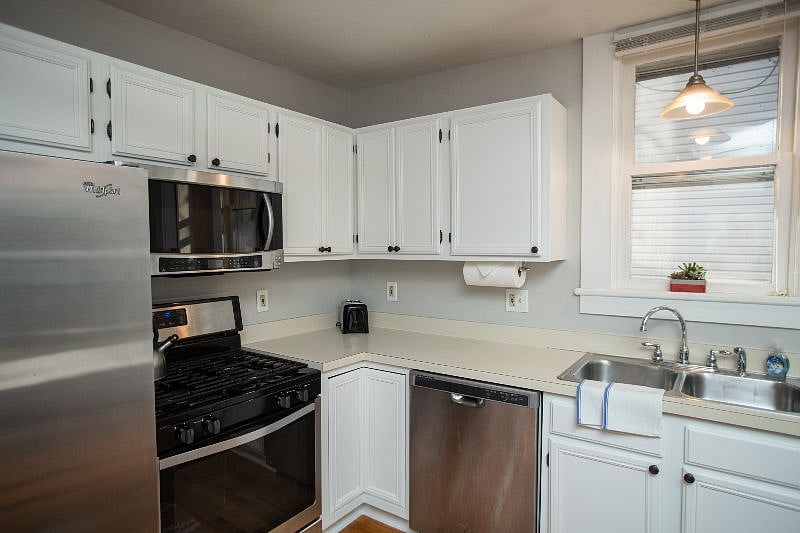 Kitchen with gas range, microwave and dishwasher.