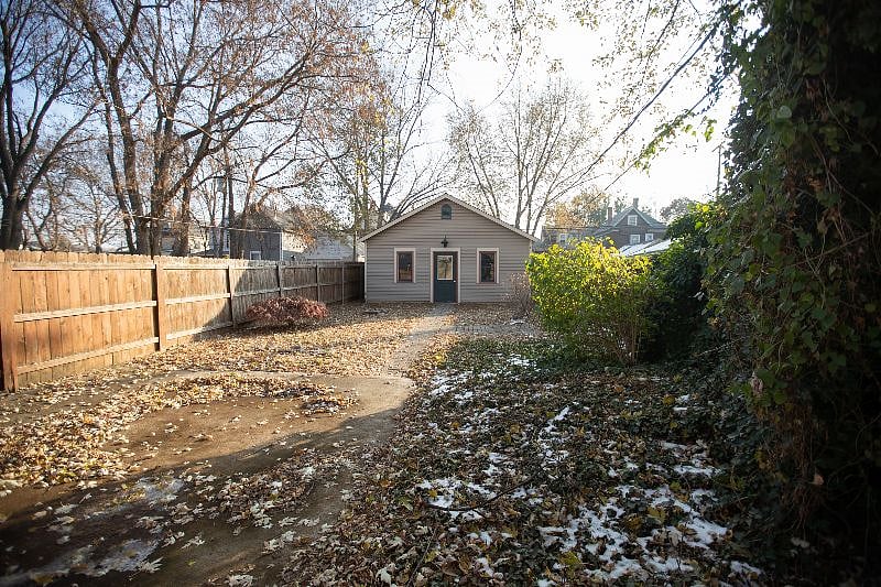 Large, fully fenced back yard looking at the 2 car garage.