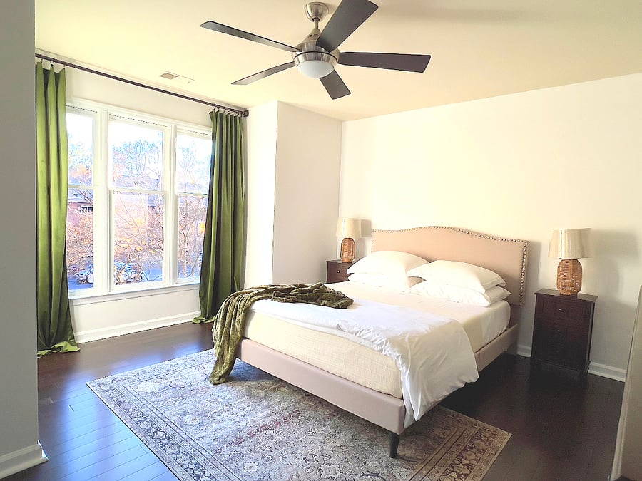 The master bedroom radiates light through the three double-hung windows, while heavy curtains let you get a great night's sleep.