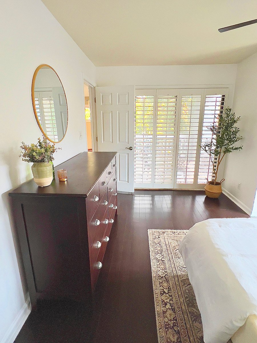 Antique chest of drawers ensures you have plenty of space for storage, plus en-suite access onto the covered balcony gives you an extra sense of privacy.