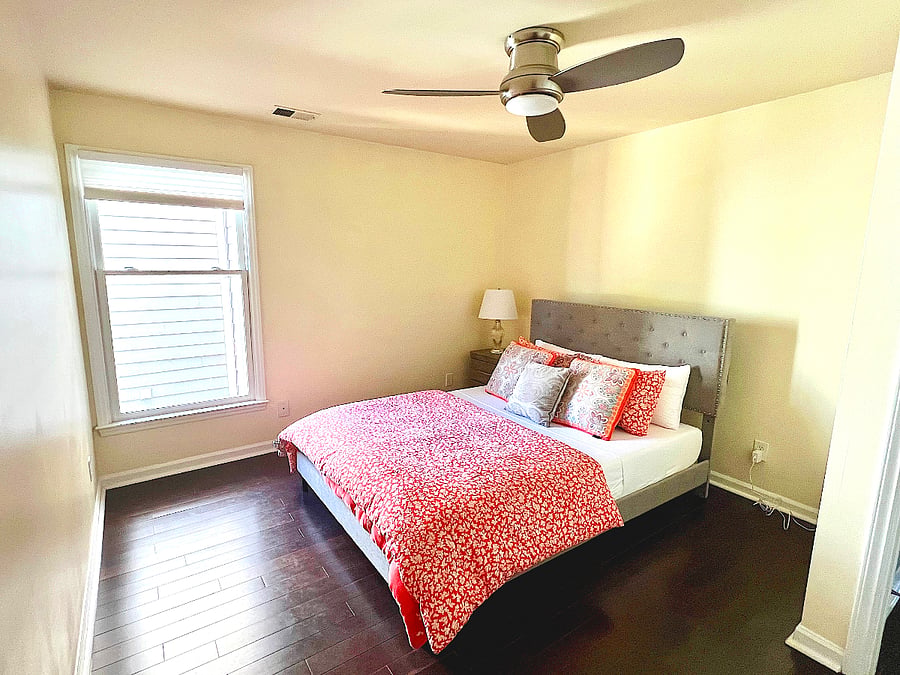 The cheerful guest bedroom - cocoon yourself in the queen bed and enjoy the spacious walk-in closet.