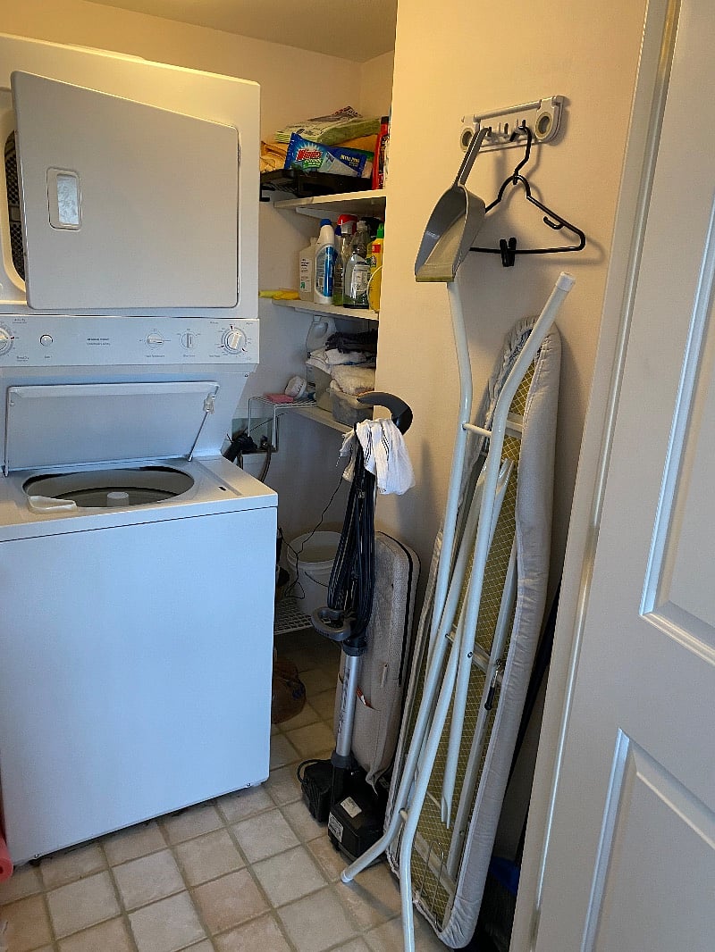 Utility room with w/d, cleaning supplies, iron and board.