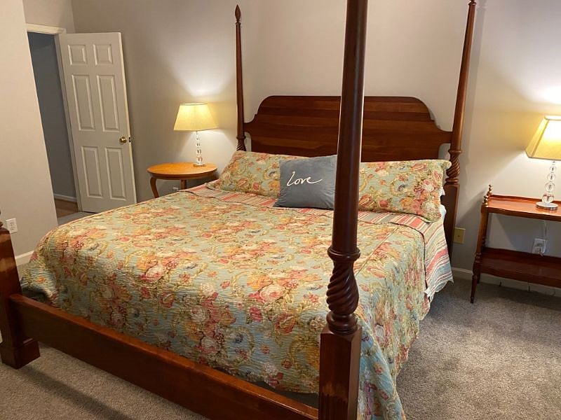 MASTER BEDROOM HAS A KING SIZE BED AND WAVERLY BED LINENS.