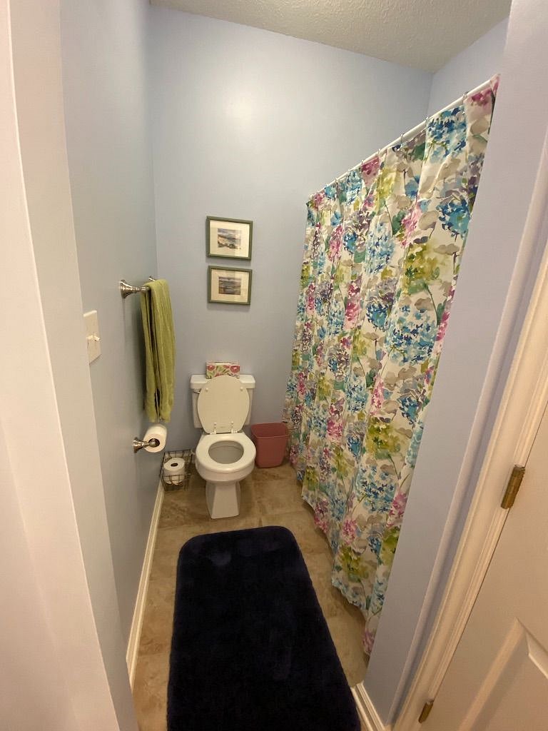 The second bath has tile floor and granite counters with dual sinks.