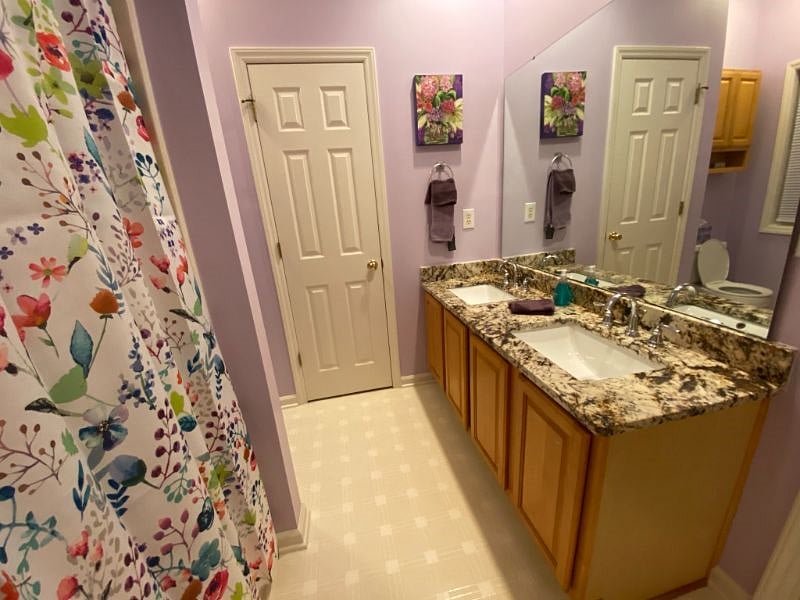 The master bathroom has granite countertops and dual sinks. There is  a linen closet for towels and sheets.