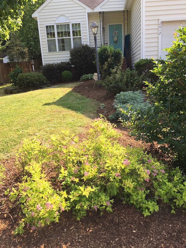 THE HOME HAS BEAUTIFUL LANDSCAPING AND A FENCED IN BACK YARD.