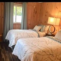 Bedroom #3 set with twin beds, Roku TV, walk in closet, ceiling fan and room darkening drapes