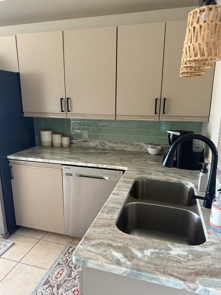Kitchen is stocked with appliances and dishes