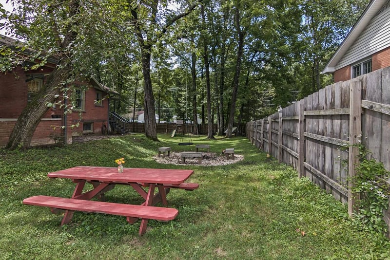 Picnic table and a fire pit in the spacious fenced yard.