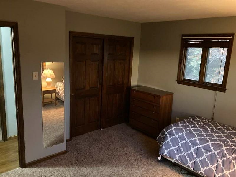 Room in question. Queen bed (bedding provided), two dressers, nightstand, smart TV, and lamp currently provided. Further amenities pending. Closet is roughly 6' wide x 20" deep
