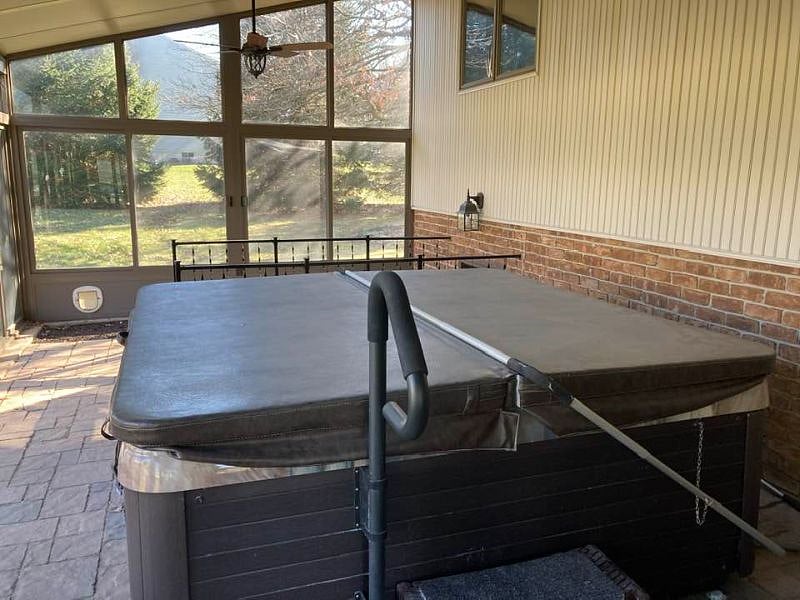 6 person hot tub in enclosed patio, on the back of the house. Summer weather, this will be drained.