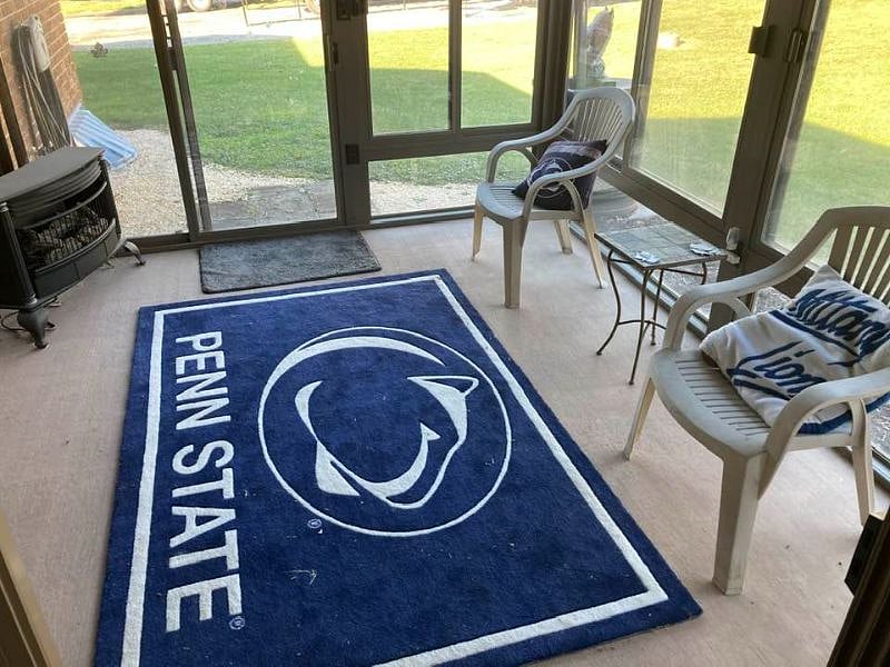 Enclosed sun room with propane fire place, connecting the kitchen and patio. I hope you like Penn State.