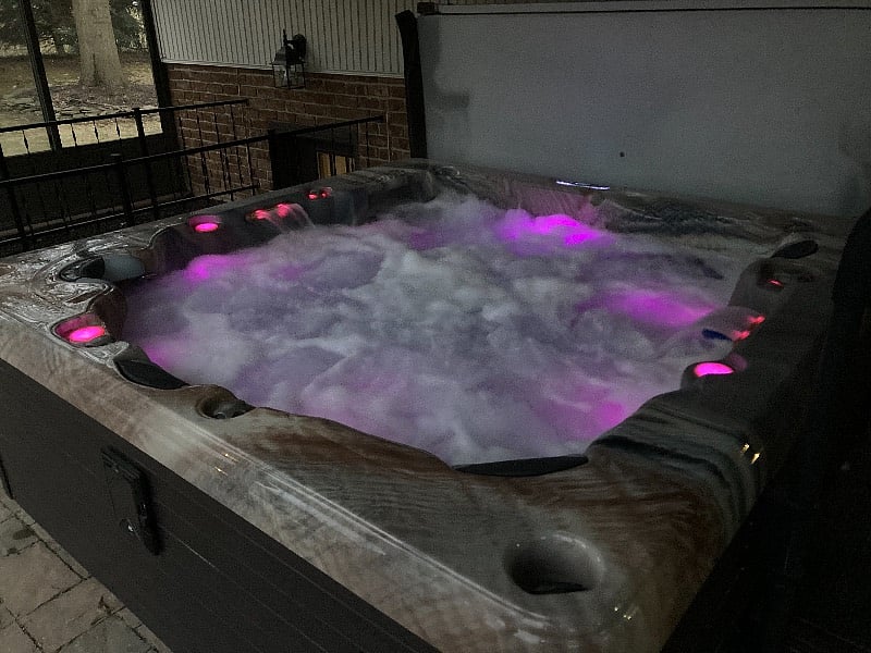 6 person hot tub in enclosed patio, on the back of the house. Summer weather, this will be drained.