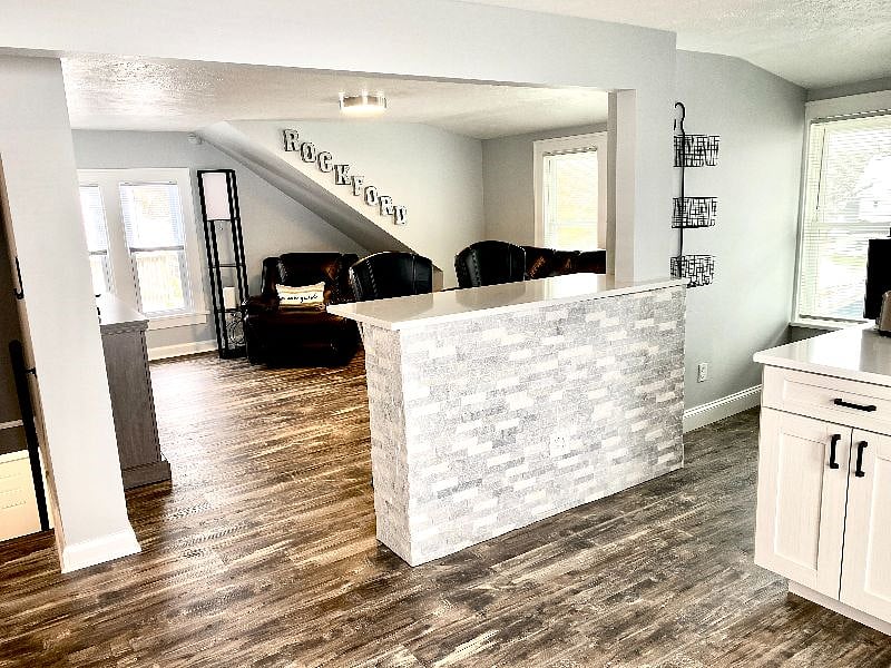 Relax in style with cozy leather recliners and a bar seating in the living area.