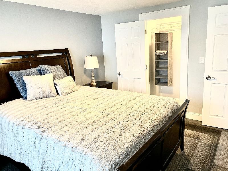 Bright, inviting bedroom with a soft & comfortable bed & walk in storage closet