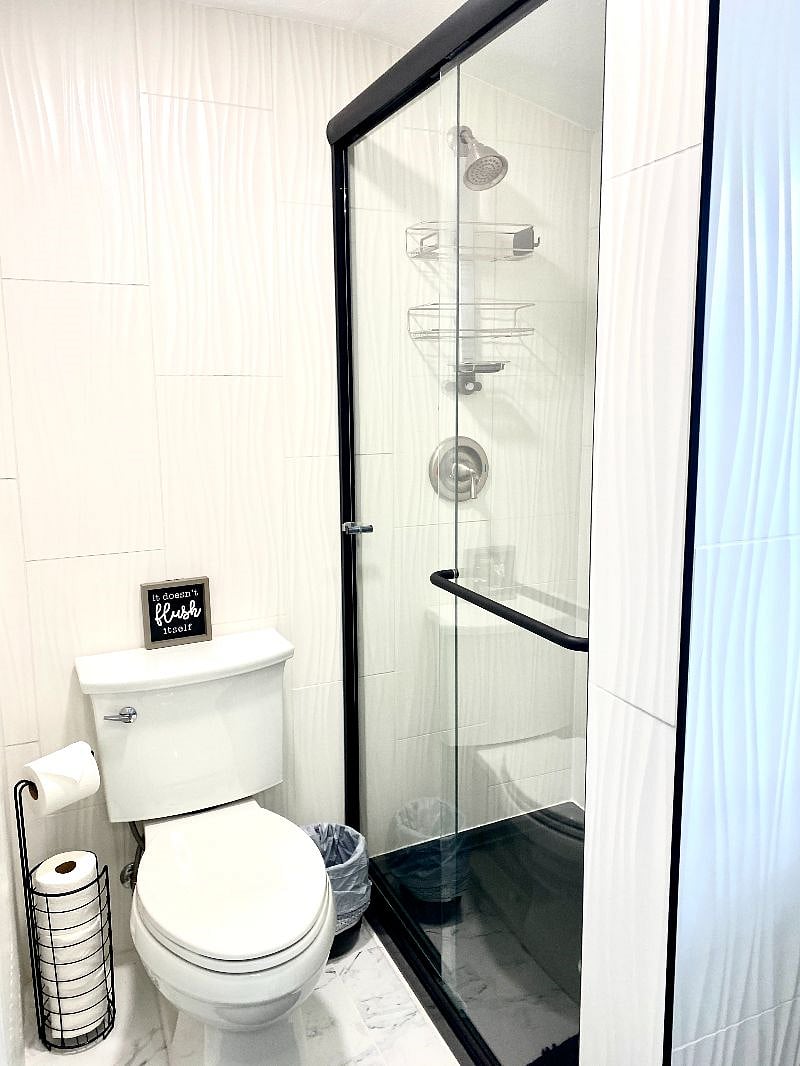 Modern bathroom with glass, enclosed shower and clean, soft water for comfort.