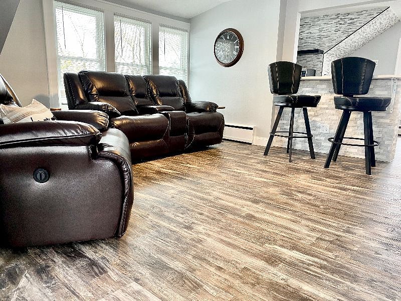 Relax in style with cozy leather recliners and a bar seating in the living area.