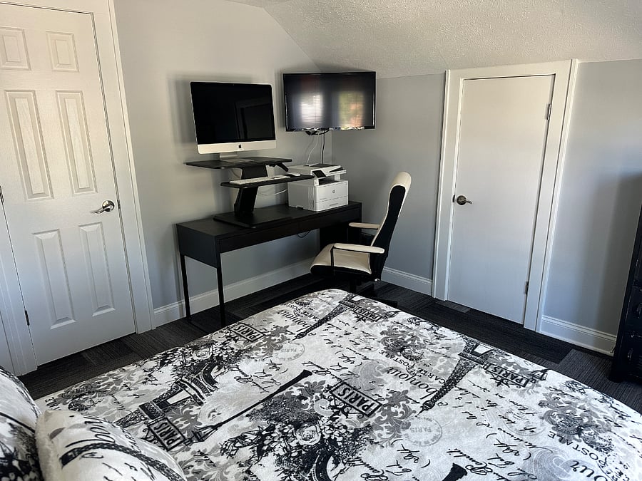 Dedicated workspace with desk, computer, printer and ergonomic chair for comfort