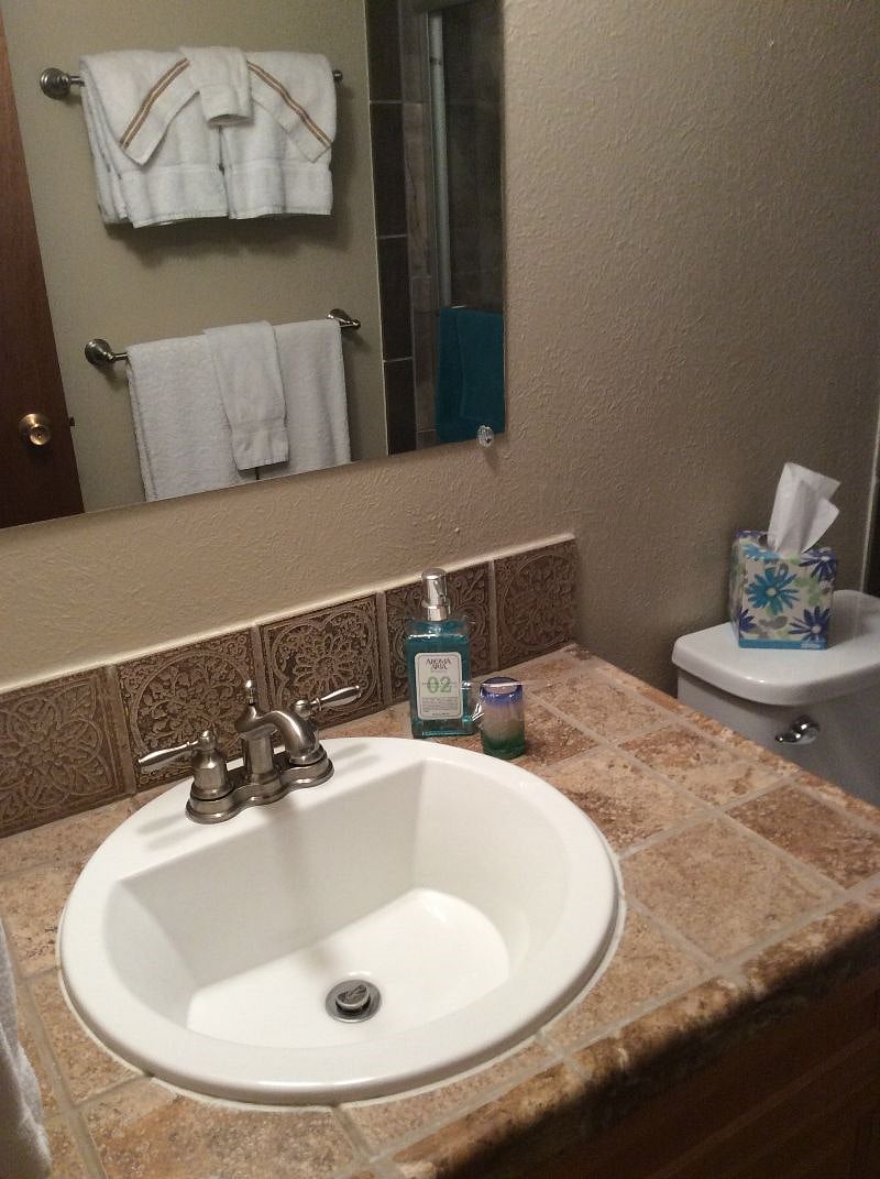 Newly tiled floor and updated basin in hall bathroom,