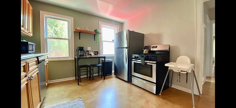Kitchen has a small eating area and a high chair is on property.